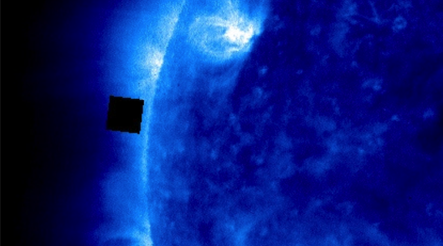 A black cubic UFO photographed near the sun